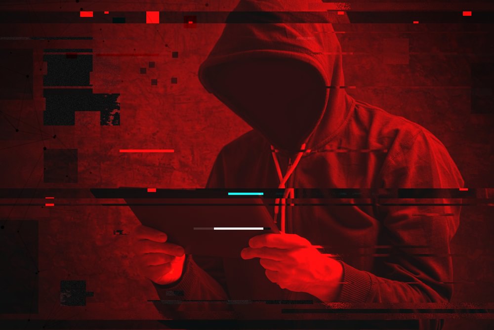 hacker with tablet