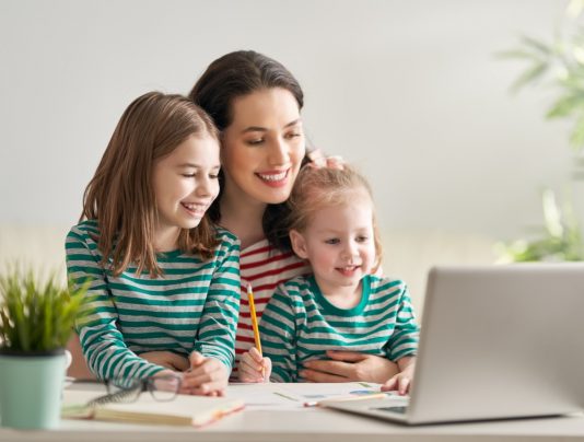mum with kids and laptop with parental controls